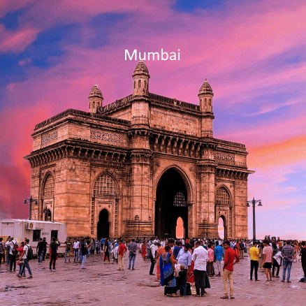 Gateway of India in Mumbai during sunset with tourists, representing travel from Dubai to Mumbai.