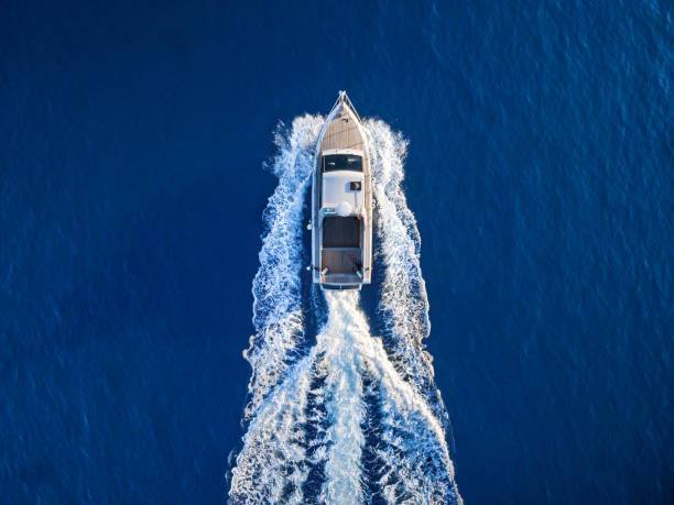 Top view of luxury motor yacht sailing in blue waters