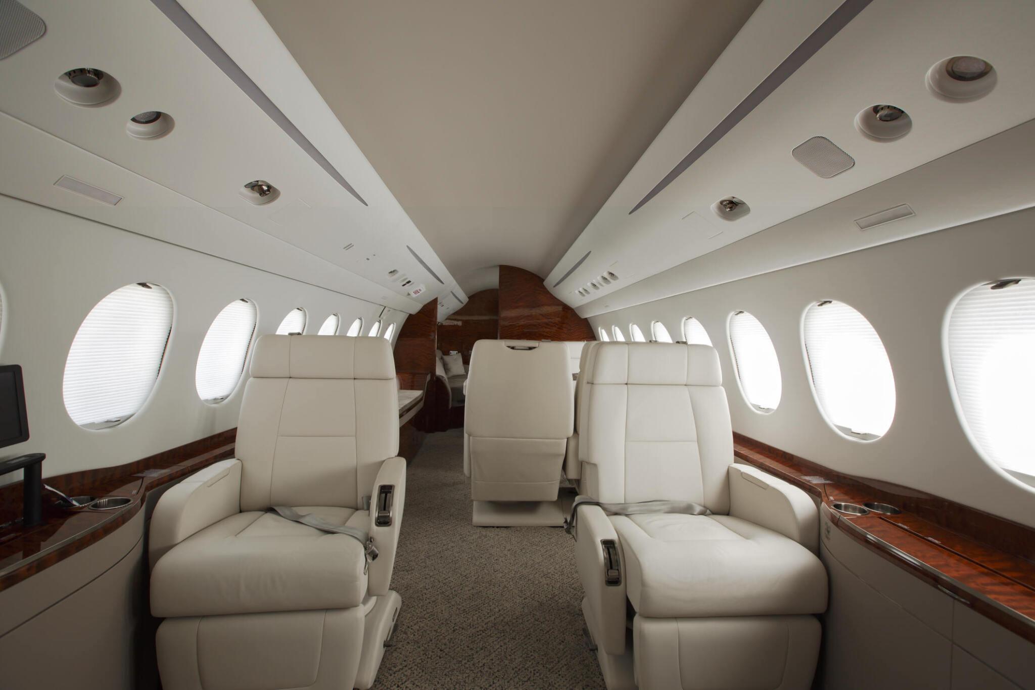 Luxurious cabin interior of a 7-seater light private jet with plush leather seating and window-side layout, ideal for short to medium-haul executive flights