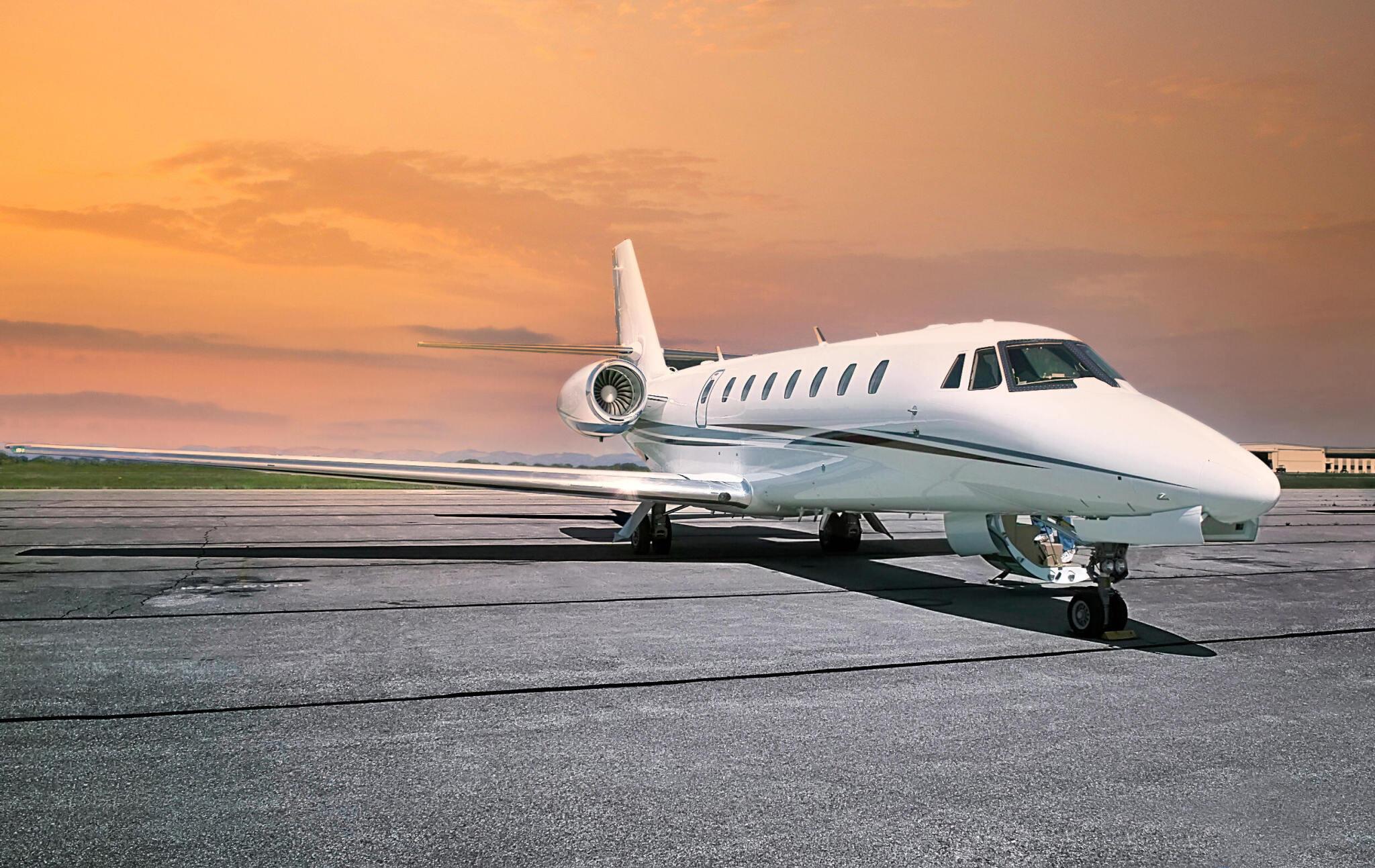 Exterior view of a compact 7-seater private jet on the runway during sunset, representing light jet class for efficient and affordable private travel