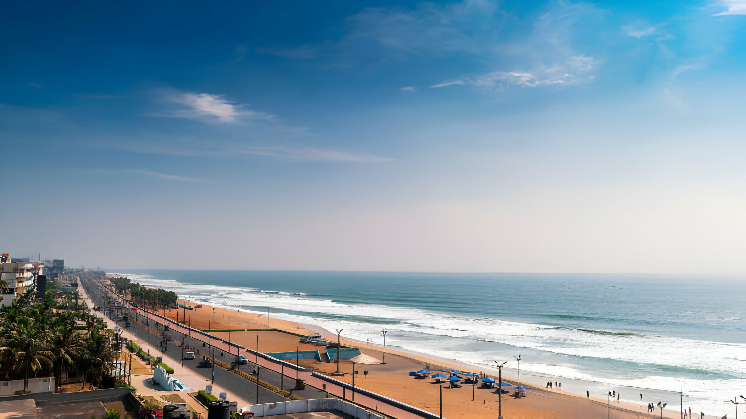 Aerial view of Visakhapatnam’s beach and promenade with palm trees and coastal buildings along the Bay of Bengal