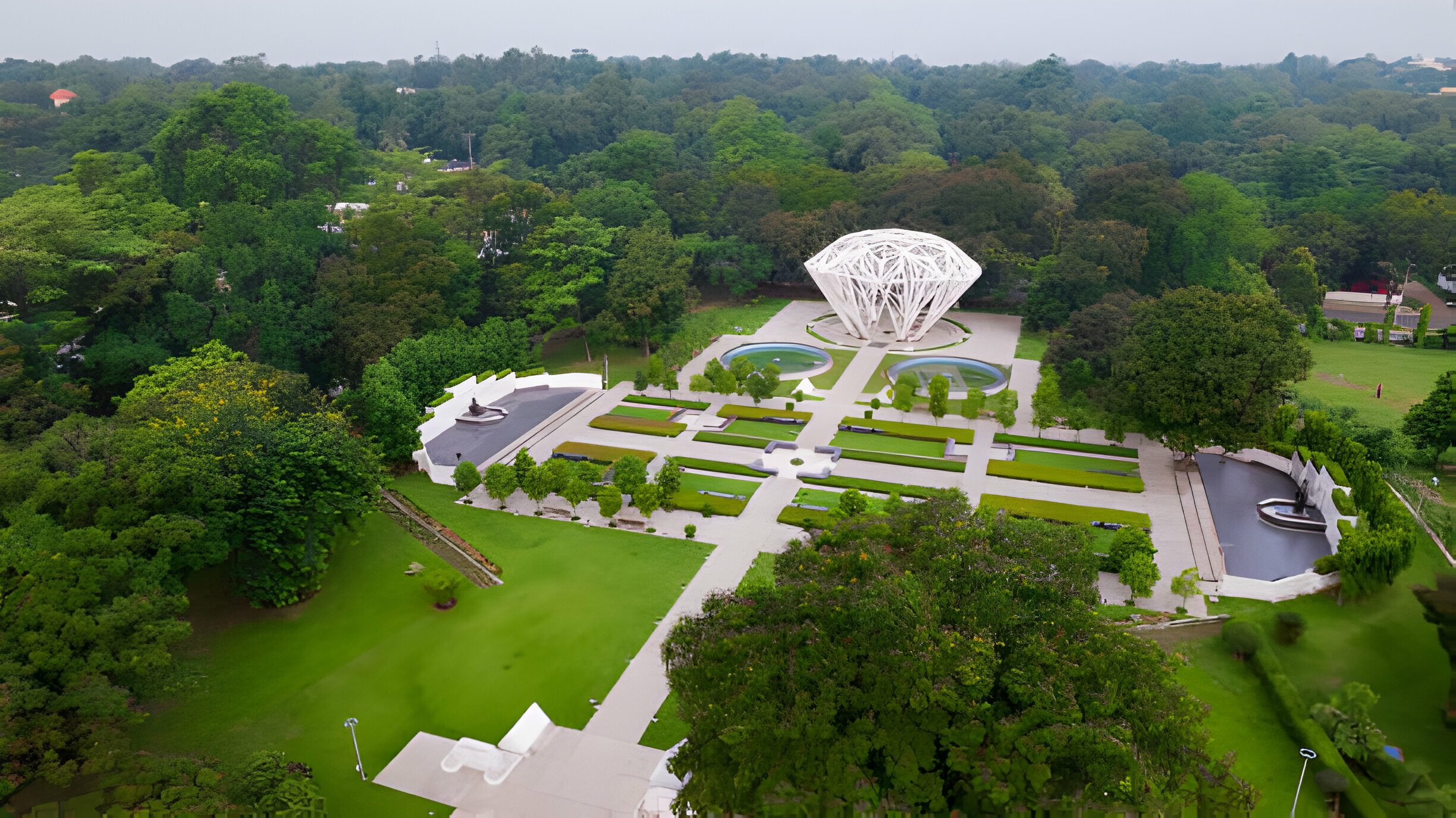 Aerial view of the tree-shaped sculpture and landscaped gardens at Jubilee Park in Jamshedpur, India, surrounded by lush greenery