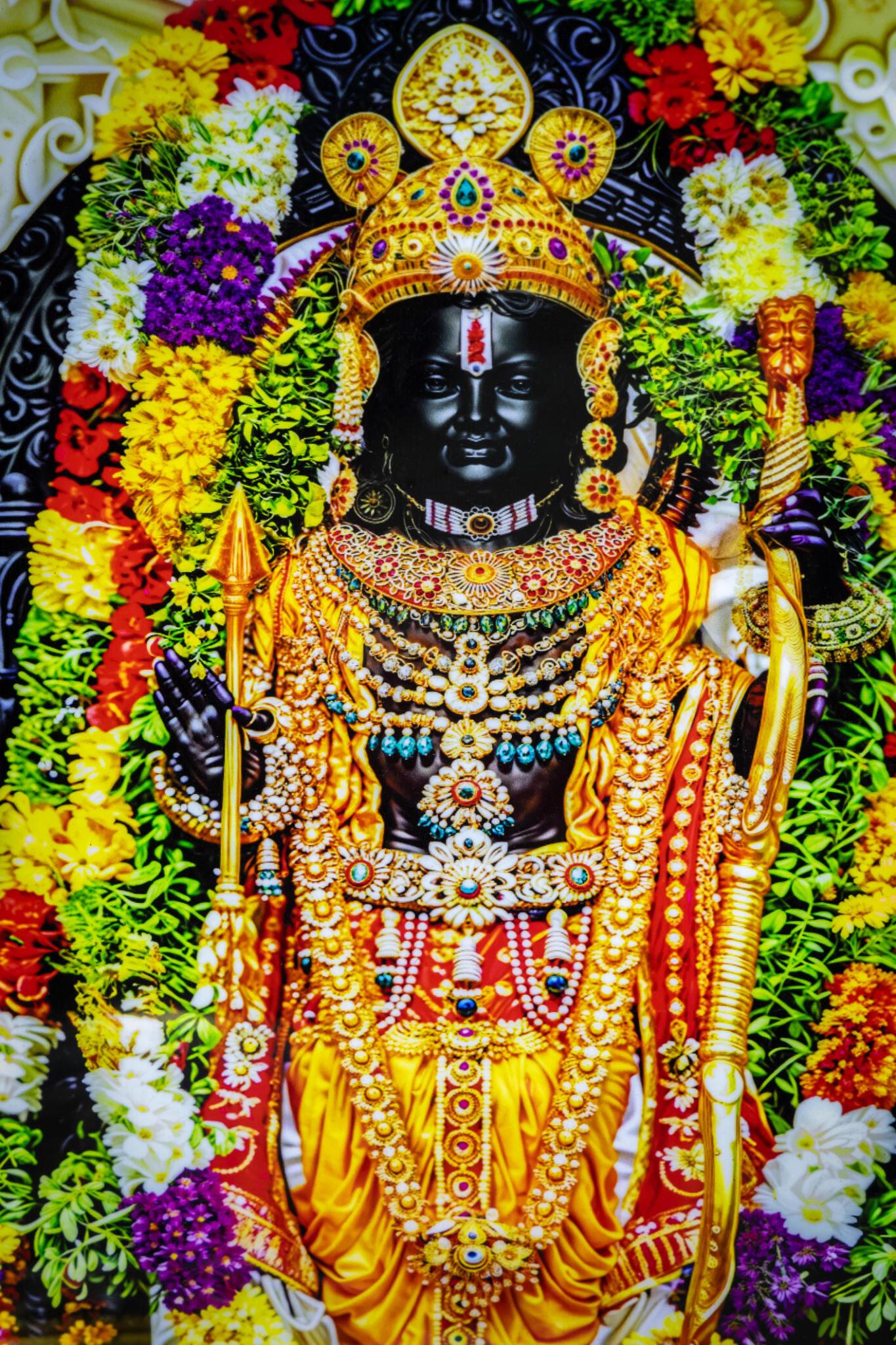 Statue of Lord Ram decorated with vibrant flowers and ornaments during festival in Ayodhya