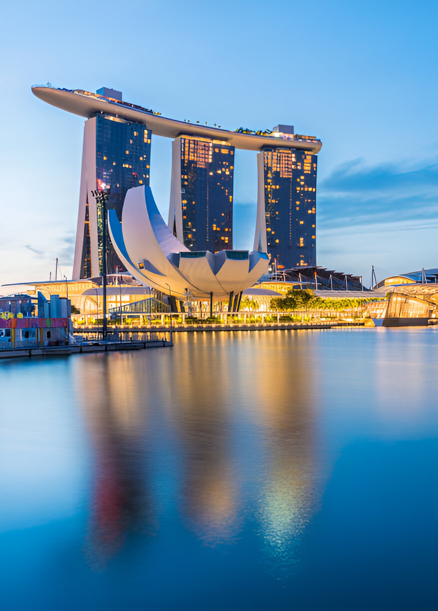 Night view of Marina Bay Sands and ArtScience Museum reflecting on the water in Singapore’s Marina Bay district
