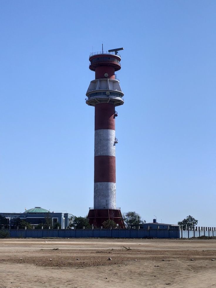 Red and white air traffic control tower in Kandla, India – aviation infrastructure