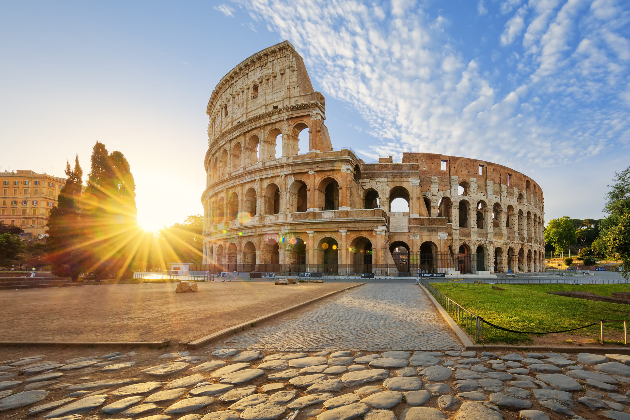 Colosseum in Rome with sunlight, representing luxury private jet travel with Fly Avcare