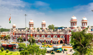 Historic Charbagh Railway Station with auto-rickshaws and traffic in Lucknow, India