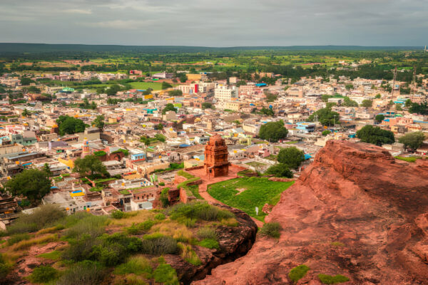 Aerial view of Badami town with red sandstone cliffs and ancient temples in Karnataka, India