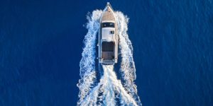 Top view of luxury motor yacht sailing in blue waters